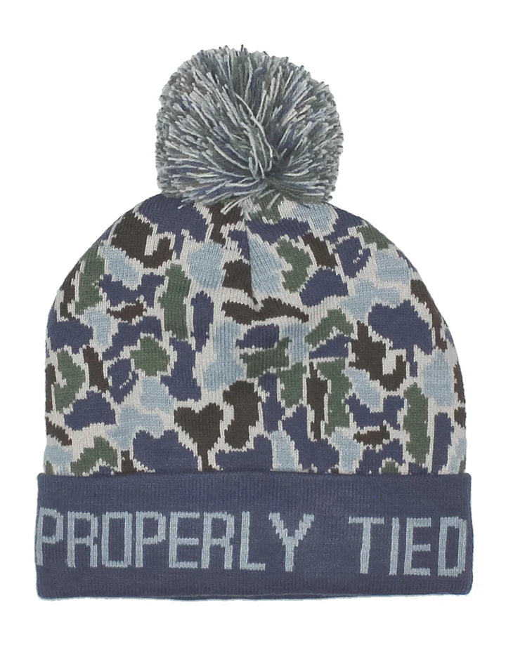 Camouflage patterned beanie with pom-pom and 'Properly Tied' text on a white background